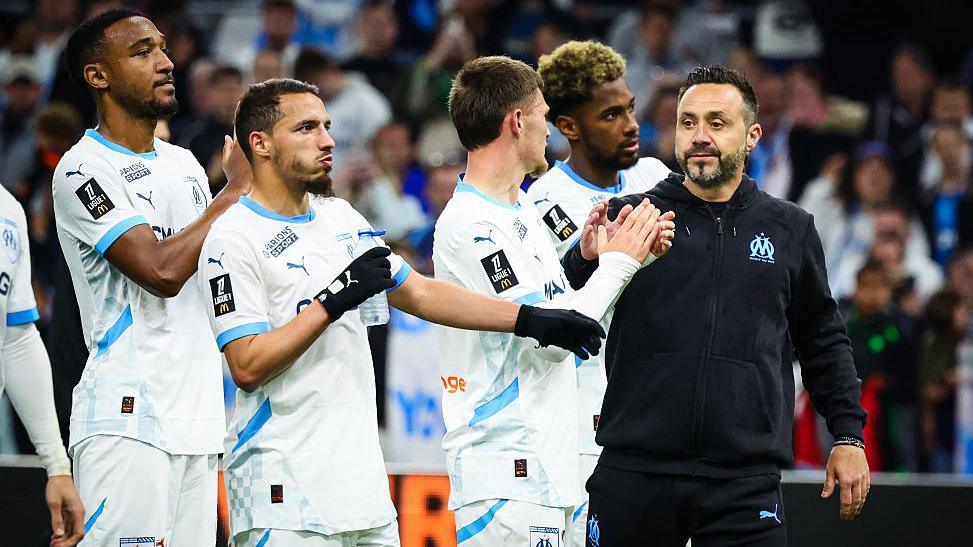 Roberto de Zerbi greets his players after a game