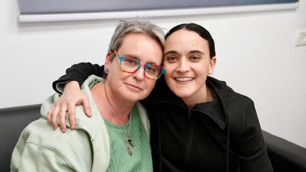 Released British-Israeli hostage Emily Damari poses for a photo with her mother, Mandy, after being held in Gaza since the 7 October attacks.