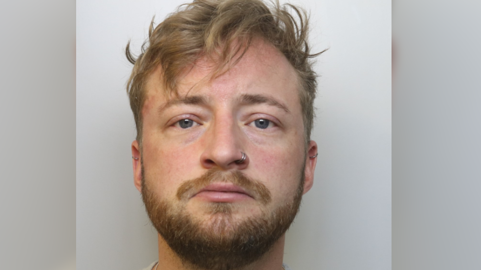 A police image of a white man called Kieron Goodwin in his early 30s looking at the camera. He has light brown hair, a light brown beard and a nose ring.