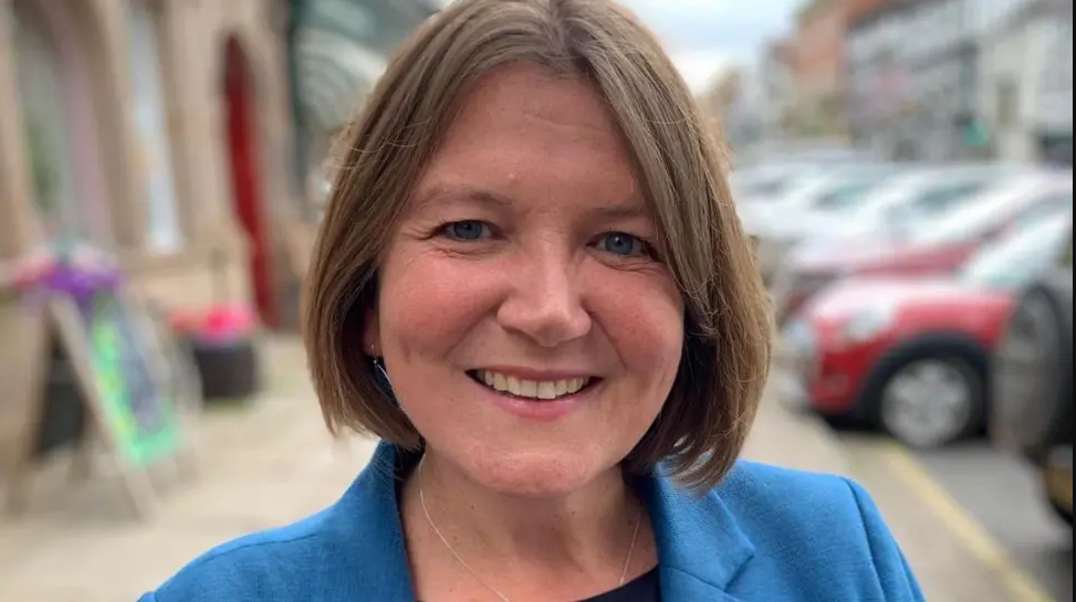 Head and shoulders image of the MP who is wearing a blue jacket with brown, bobbed hair and she is smiling at the camera