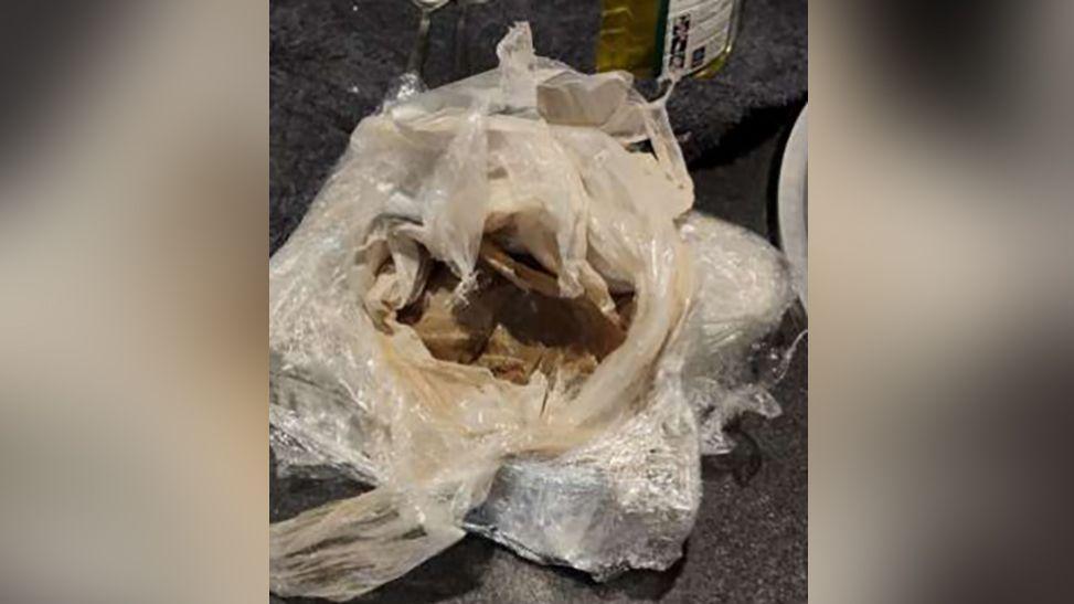 A plastic bag and cling film containing heroin seized in police raids.
