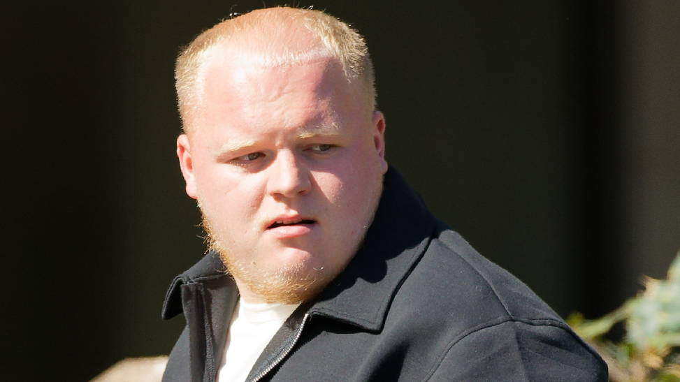 McKenzie Danks arrives at Newport Crown Court on Monday 22 September 2025. He has short ginger hair and a beard, and wears a white t-shirt with a black zipped jacket.