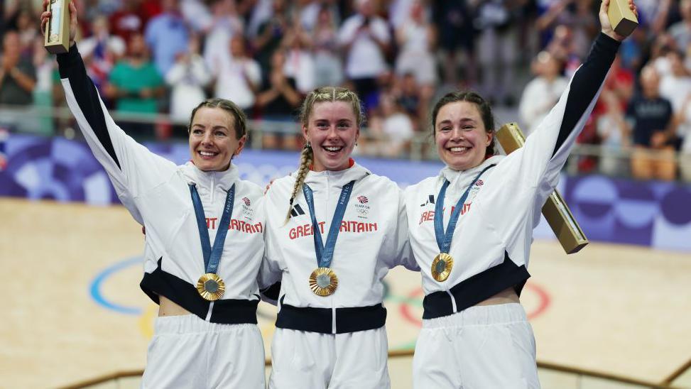 Emma Finucane, Sophie Capewell and Katy Marchant hold their gold medals and smile