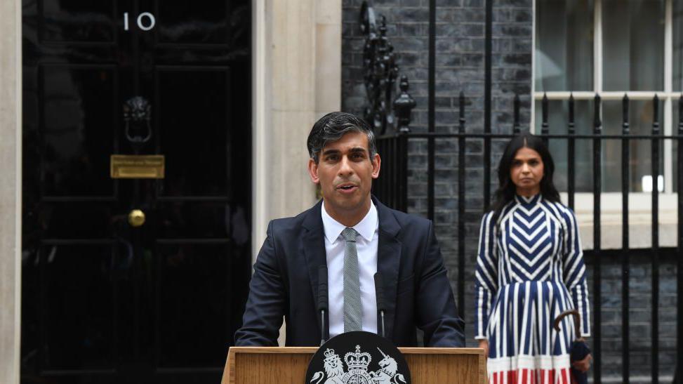 Rishi Sunak and Akshata Murty, his wife, making a speech at Downing Street