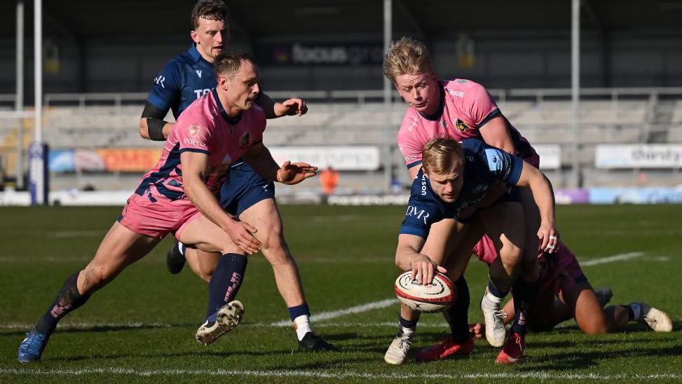 Arron Reed bursts through Exeter's defence to score a try 