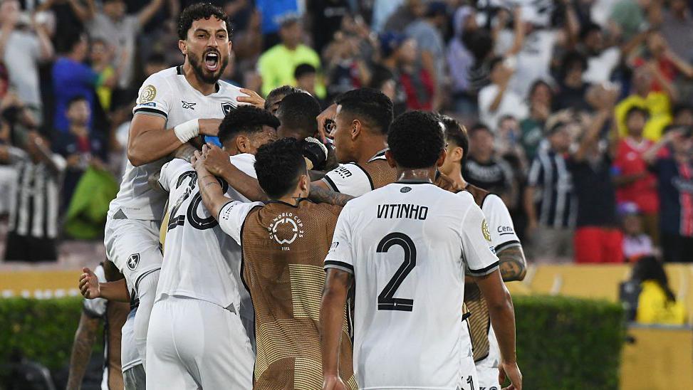 Botafogo players huddle together at the final whistle after beating PSG in their Club World Cup group game