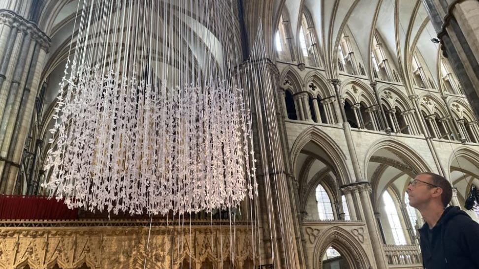 Peter Walker on the right hand side looking up at the Peace Doves installation.