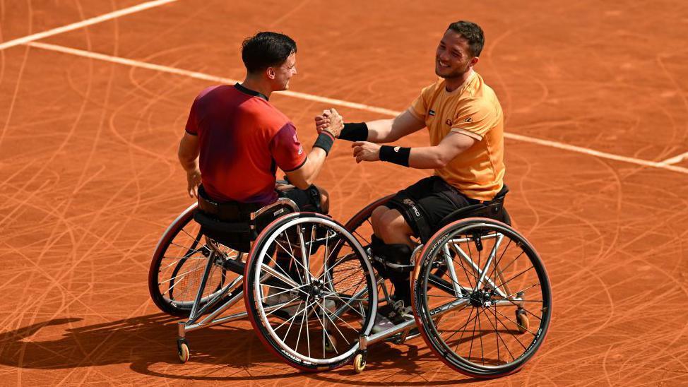 Gordon Reid and Alfie Hewett celebrate their French Open wheelchair doubles title at Roland Garros in 2024