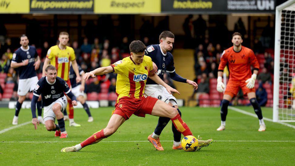 Luca Kjerrumgaard battling for the ball against Millwall at Vicarage Road