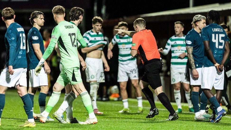Referee John Beaton points to the spot, awarding Celtic a dramatic late penalty kick