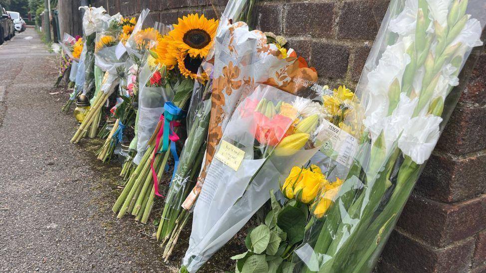 Bouquets of flowers against a wall