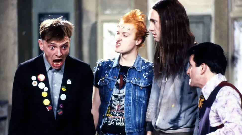 Rik in character in The Young Ones with other actors in the BBC series.