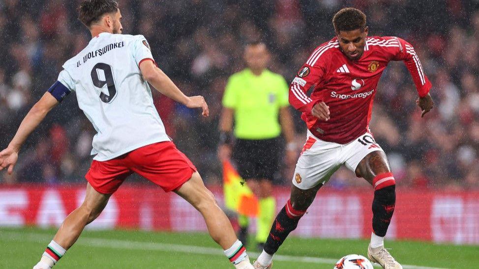 Manchester United striker Marcus Rashford takes on Twente's Ricky van Wolfswinkel in the Europa League match at Old Trafford