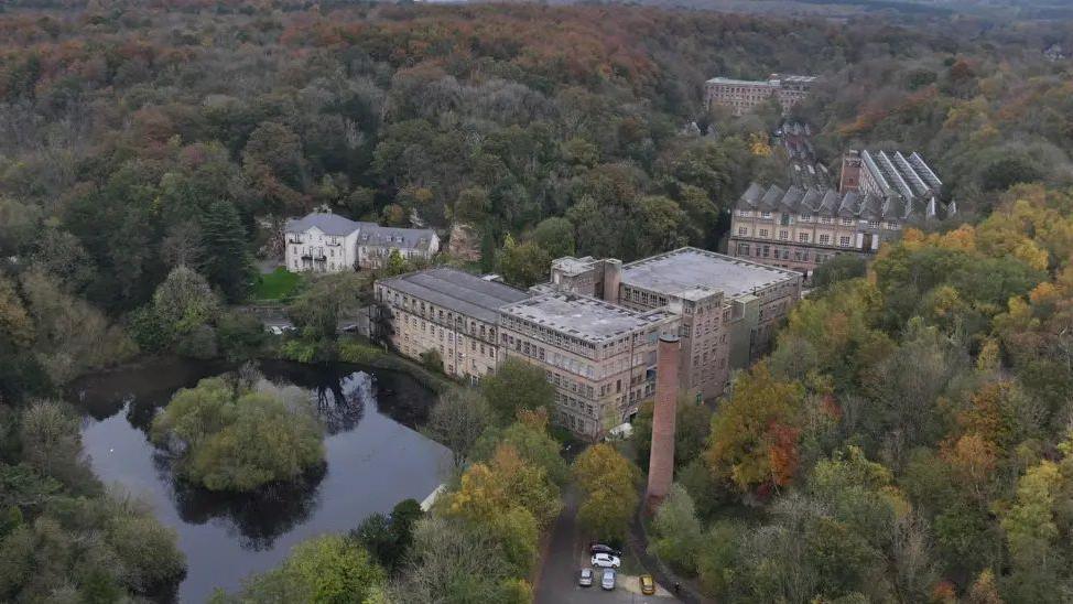 Arial view of Pleasley Vale Business Park - a large grey building surrounded by lots of trees