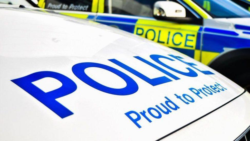 A close up of a police car's bonnet. It reads: "Police. Proud to protect."