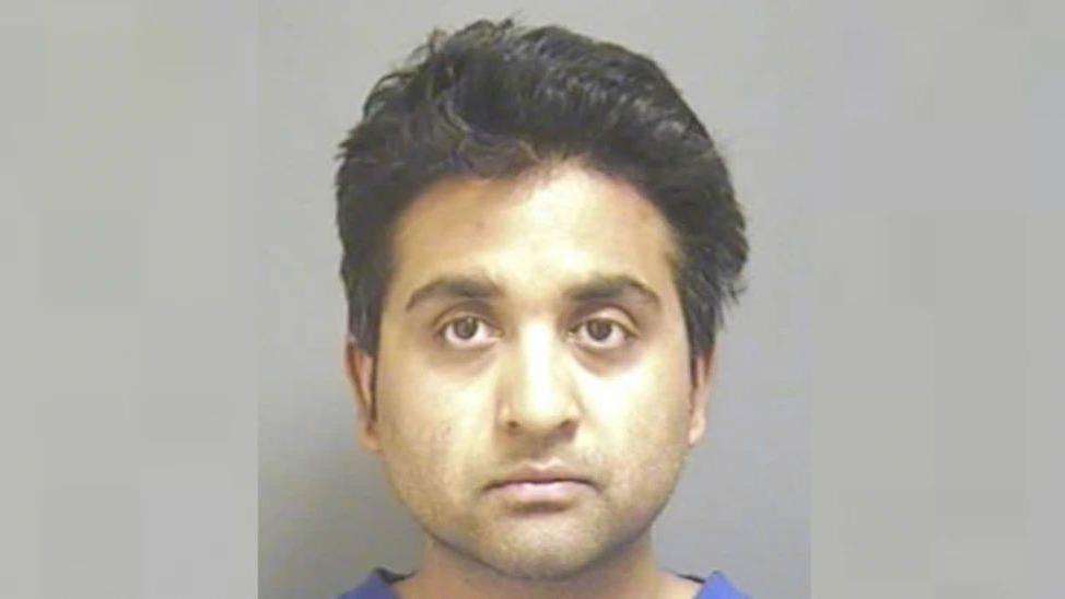 Police mugshot of Salil Korambayil who is wearing scrubs