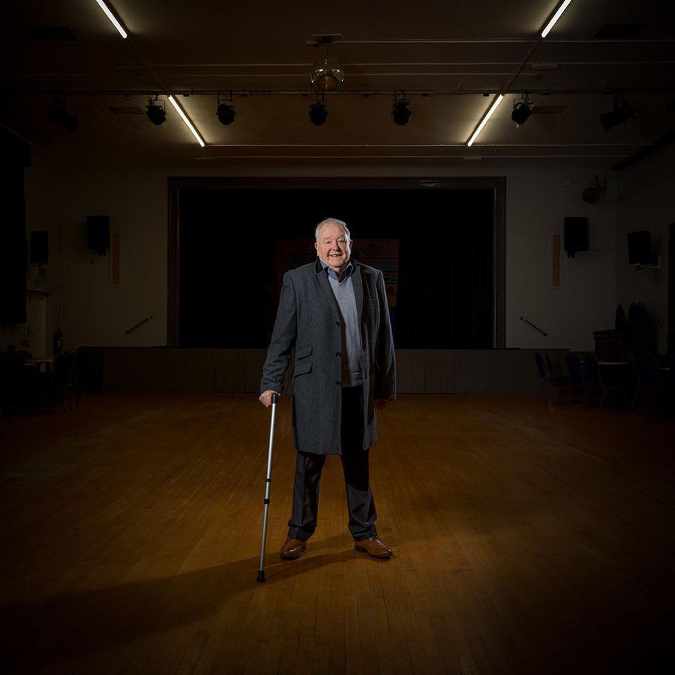 Former miner standing with walking stick