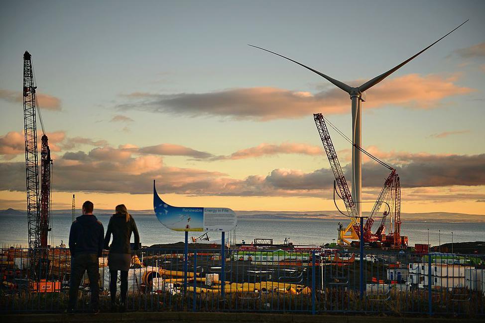 Two people look across the yard at Methil in 2013 when the yard was used for testing a large and powerful wind turbine.