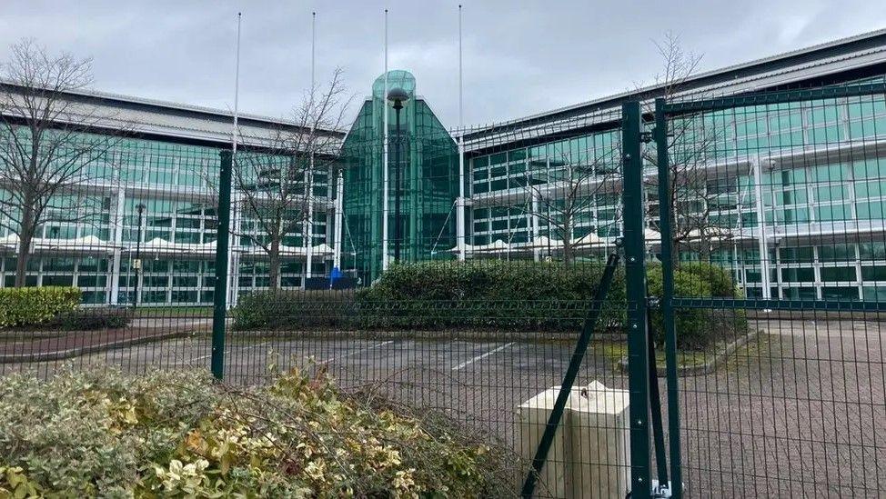 A wide photo of the front of Kings Leadership Academy in Wavertree, behind fencing