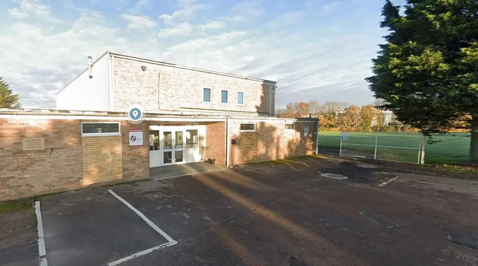 Picture shows the outside of the Wall's Social club, it's car park and a sports field