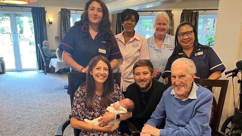 Jess Hannam, Joe Illsley, baby Louie with staff and residents at Bagshot Gardens Care Home