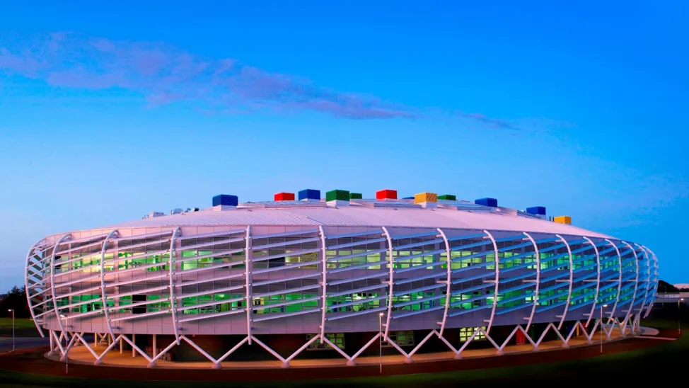 Colourful, oval-shaped futuristic-looking Monkseaton High School which has multi-coloured bricks.