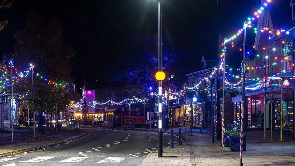 A street in Portishead town centre covered in Christmas lights.