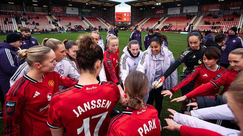 Manchester United players in a group huddle