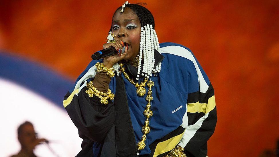 Lauryn Hill performing in a blue jacket during Drake's set