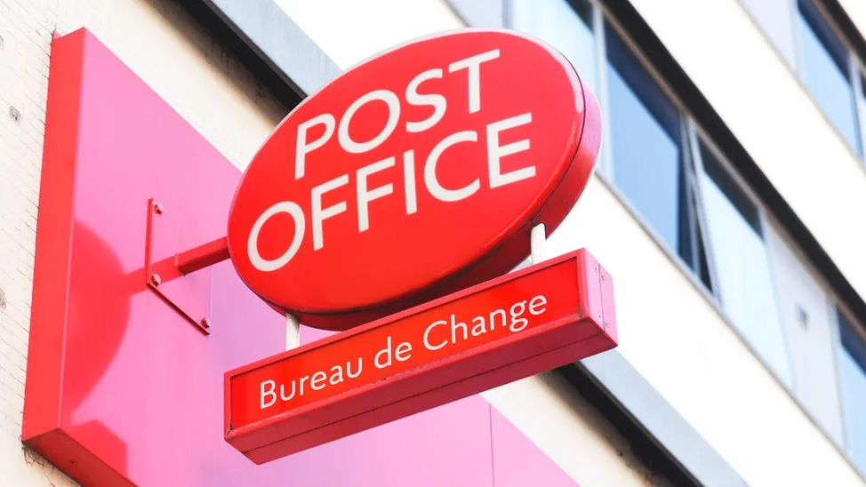 Post Office sign on building