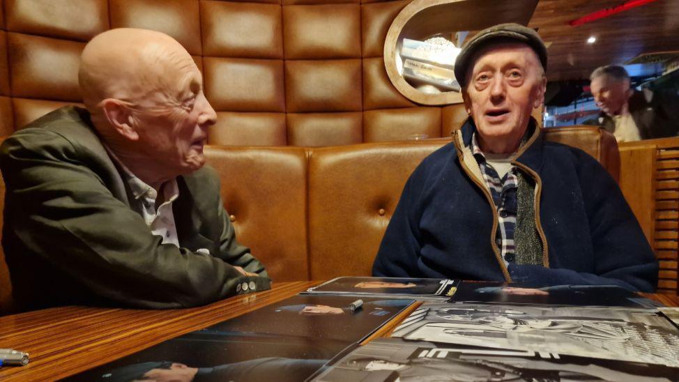 Kenneth Colley (right) and actor Michael Culver sat at a booth at an event. 
