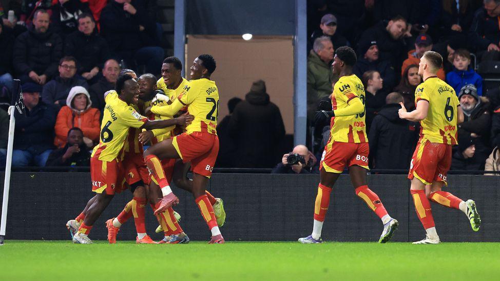 Watford players celebrate a goal against Derby County. 
