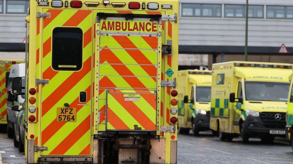 An ambulance is parked outside a hospital