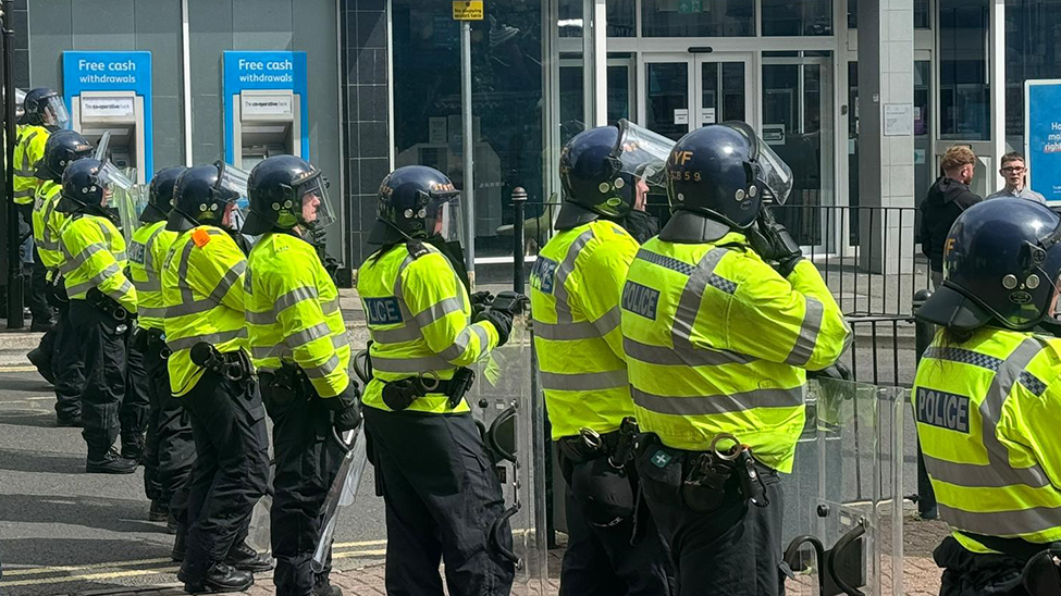 Riot police lined up in a street in Stoke-on-Trent.