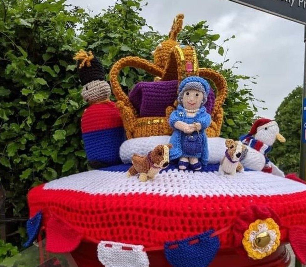 A knitted post box topper