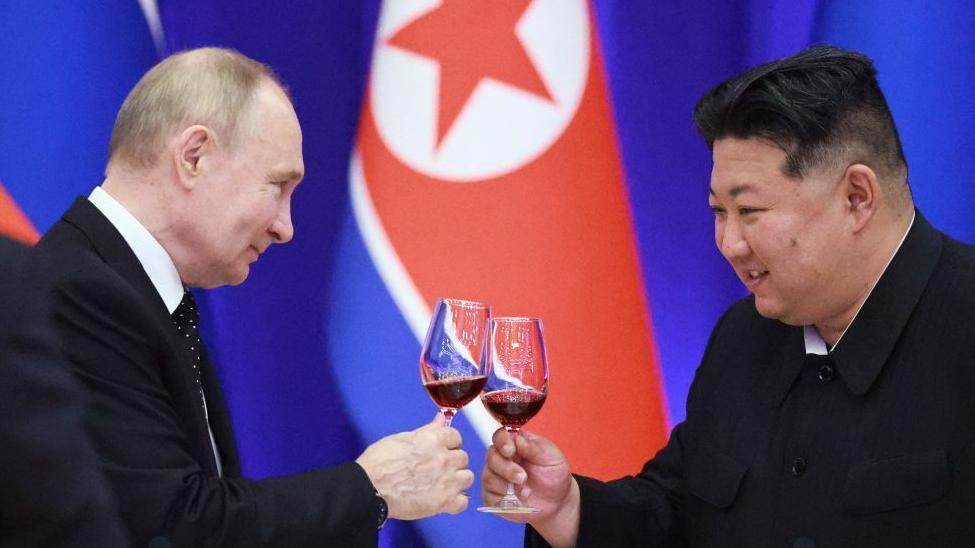 Russian President Vladimir Putin and North Korean leader Kim Jong Un toast during a reception at the Mongnangwan Reception House in Pyongyang on June 19, 2024