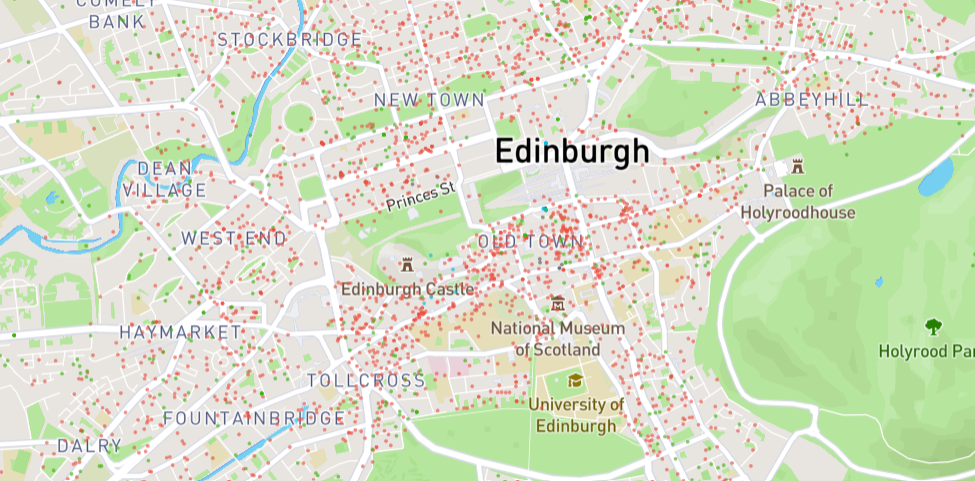 An ariel view of the city centre of Edinburgh with hundreds of red dots which mark available Airbnb properties