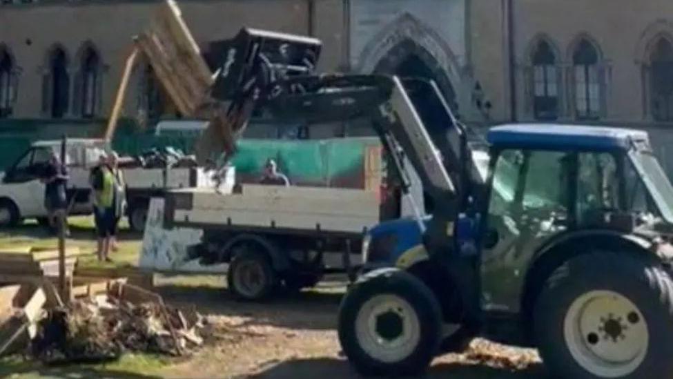 A tractor working in front of the Museum of Natural History 