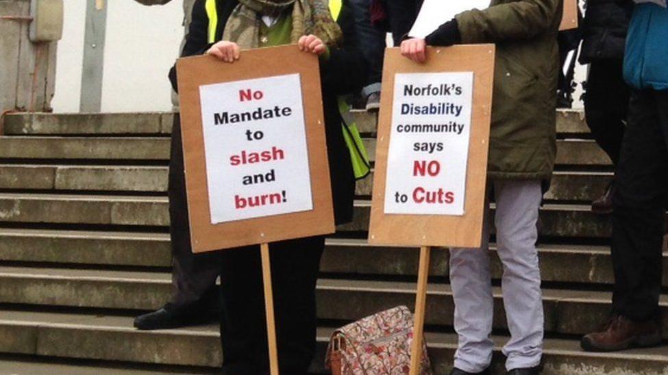 Disability campaigners with placards