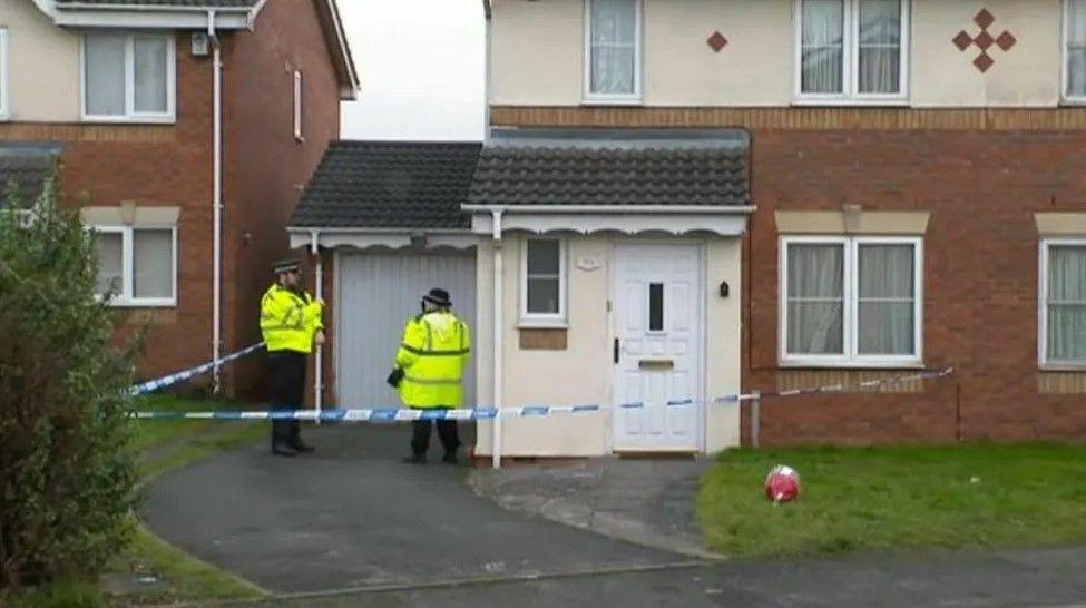 House with police tape outside