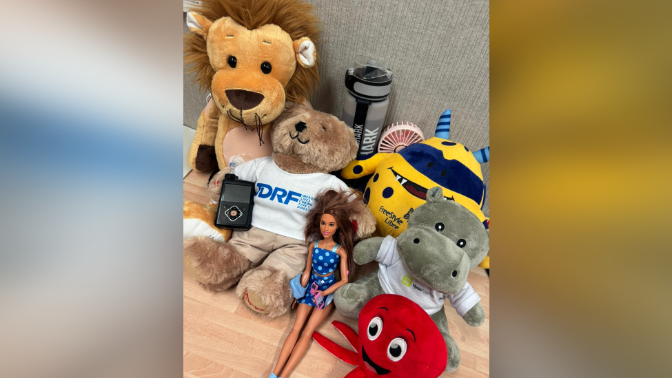 A pile of toys, including a cuddly bear, rhino and lion