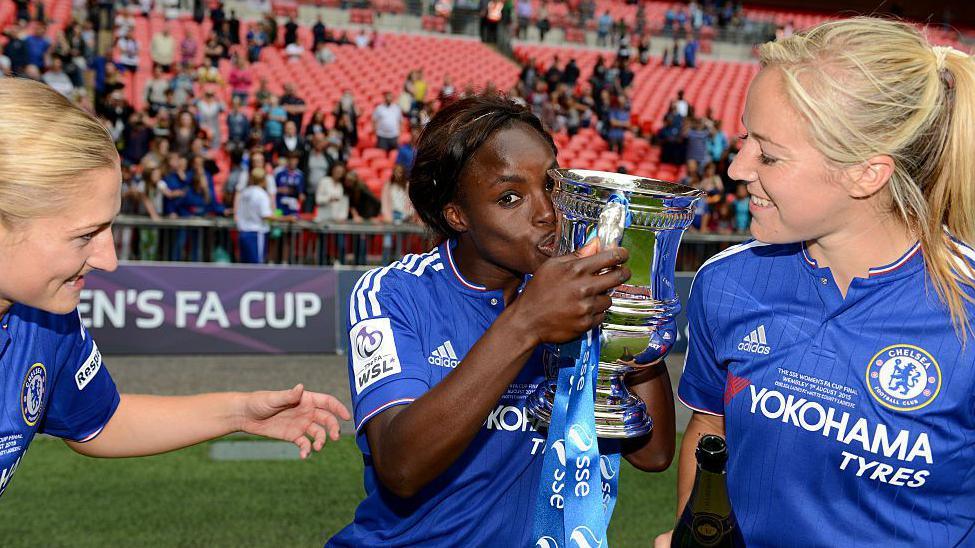 Eni Aluko kisses the FA Cup trophy on the Wembley Stadium pitch after winning it with Chelsea in 2015