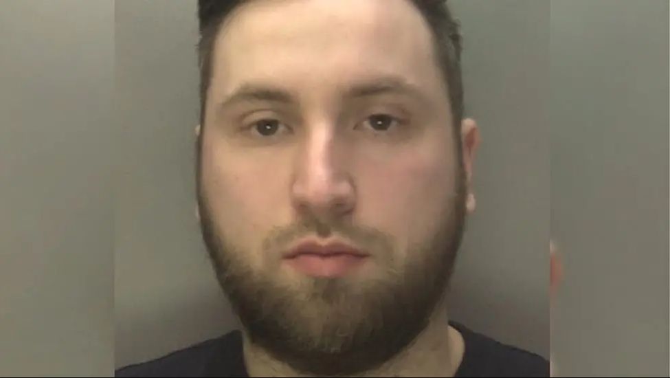 A mugshot of David Biddell-Portman wearing a black t-shirt