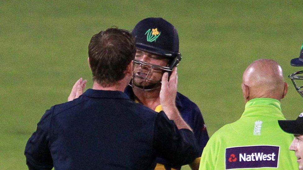 Graham Wagg is examined by a physio after being hit on the head