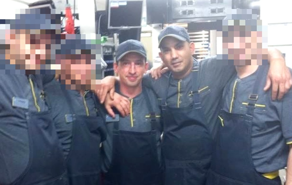 A photograph of Pavel and Roman with colleauges at the McDonald's branch.