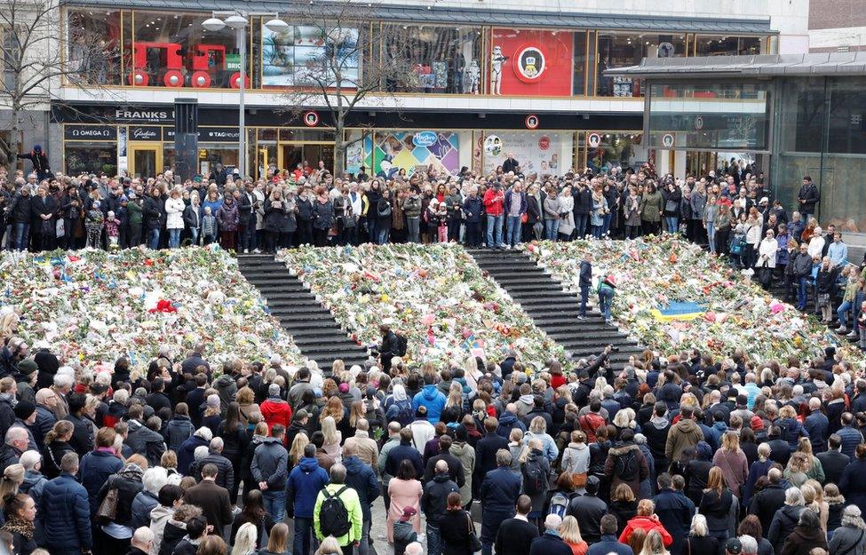 People observe a minute of silence at noon on Sergels Torg to remember the victims of Friday"s attack on Drottninggatan, Stockholm, Monday, April 10, 2017