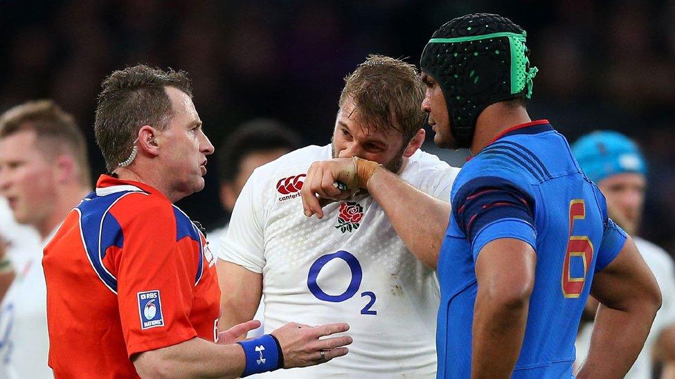 Nigel Owens in discussion with England captain Chris Robshaw and France's Thierry Dusautoir