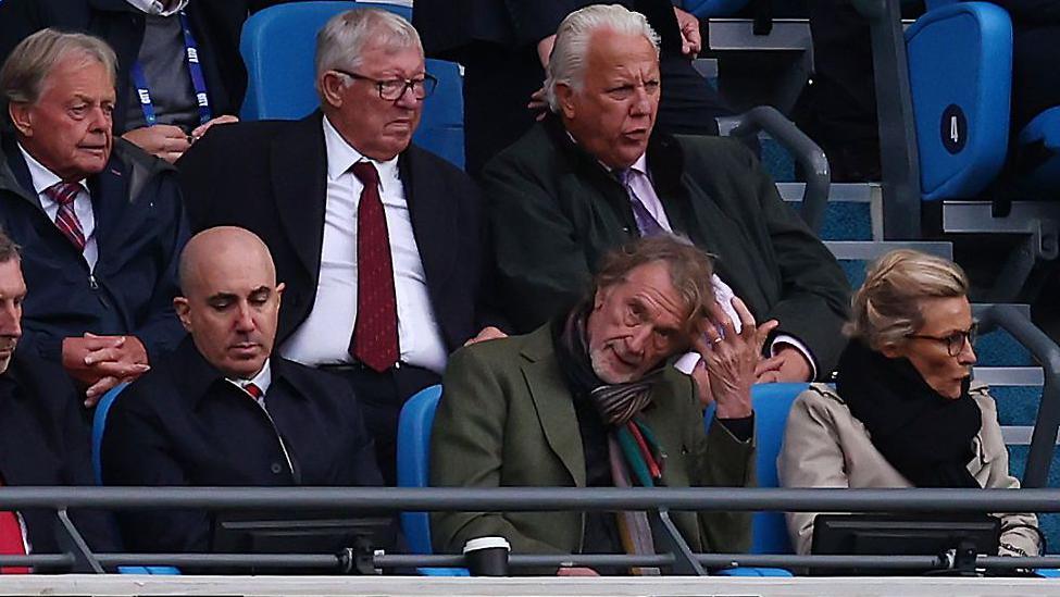 Jim Ratcliffe sitting in the stands at Etihad Stadium