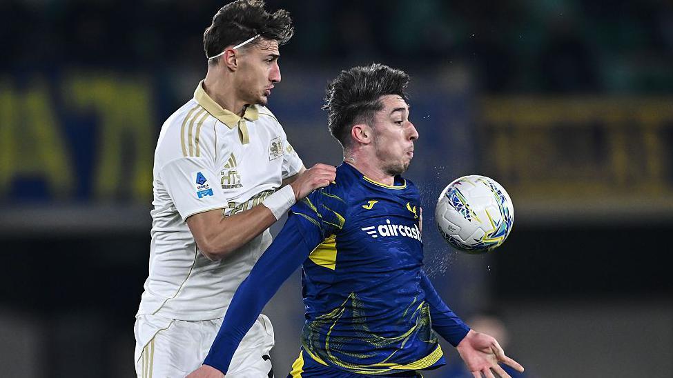  Rosen Bozhinov of Pisa competes for the ball with Kieron Bowie of Verona