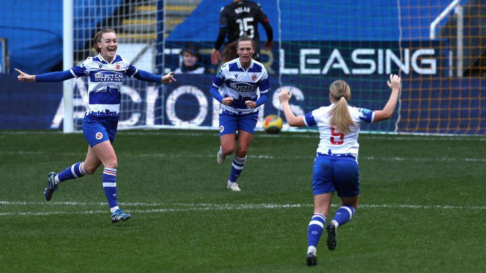 Reading players celebrate scoring a goal at the SCL Stadium. 